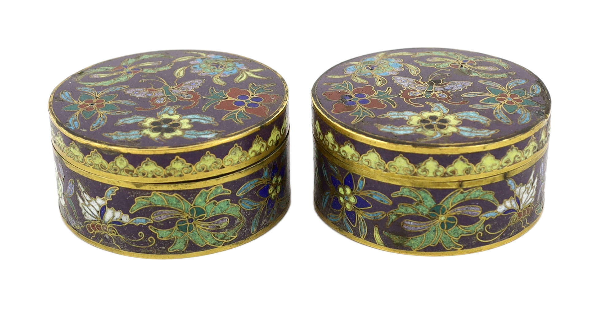A pair of Chinese purple ground cloisonné enamel circular boxes and covers, 19th century, small losses enamel